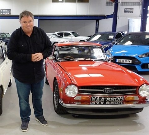 Mike Brewer with a classic red car in auction