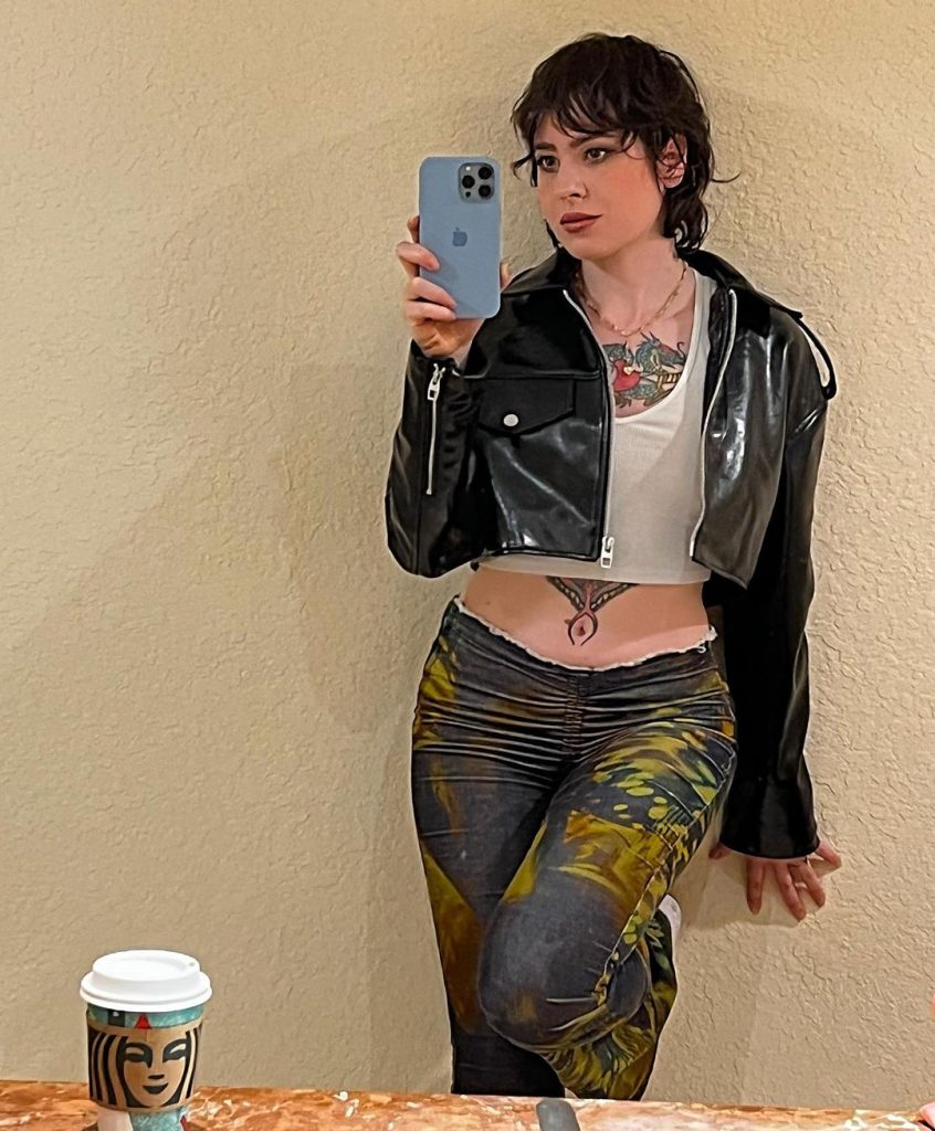 Anisa Jomha taking a selfie in black leather jacket