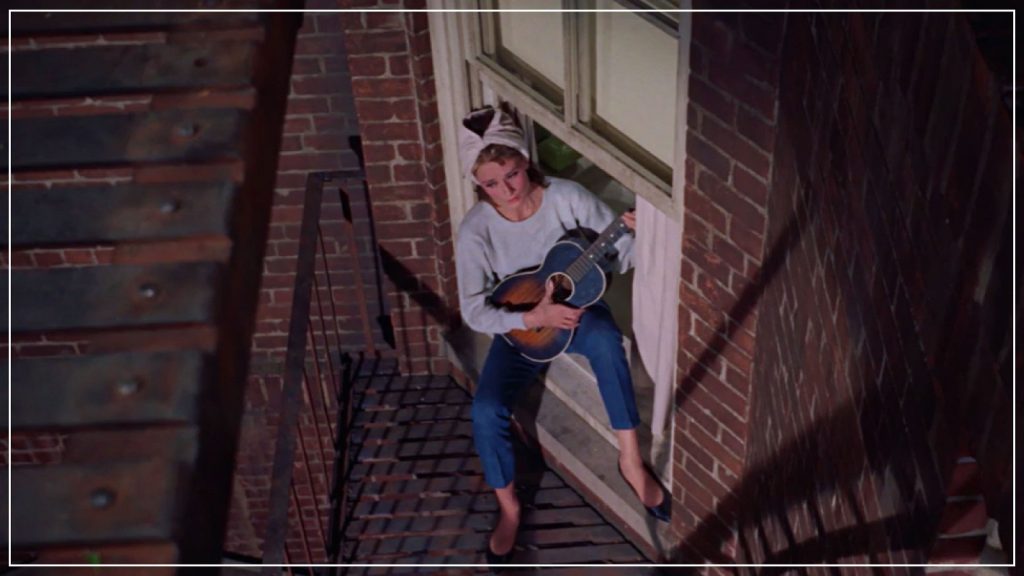 Audrey Hepburn holding Guitar