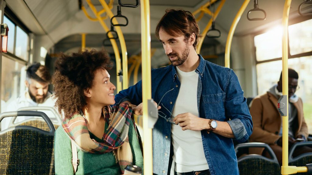 a girl and guy talking in the bus
